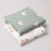 Folded baby muslin swaddles with Minty Duck and Fluffy Sheep prints on soft organic cotton